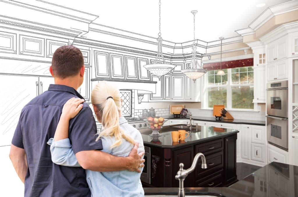 Couple envisioning kitchen renovation with drawings.