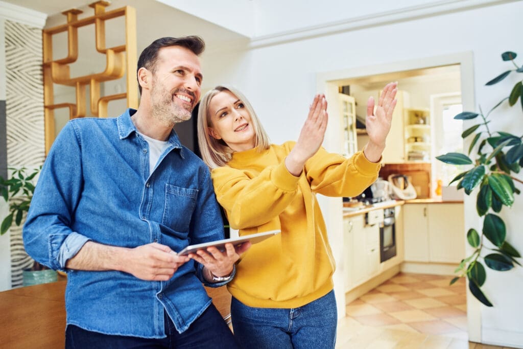 Couple planning home renovation with tablet.